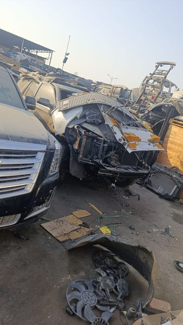 Black Cadillac Escalade SUV halfcut — grille, headlights and exposed radiator support, Sharjah market