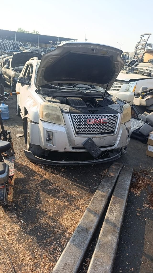 Silver GMC Terrain SUV halfcut with open hood — front bumper, grille, headlights and engine bay, Sharjah market