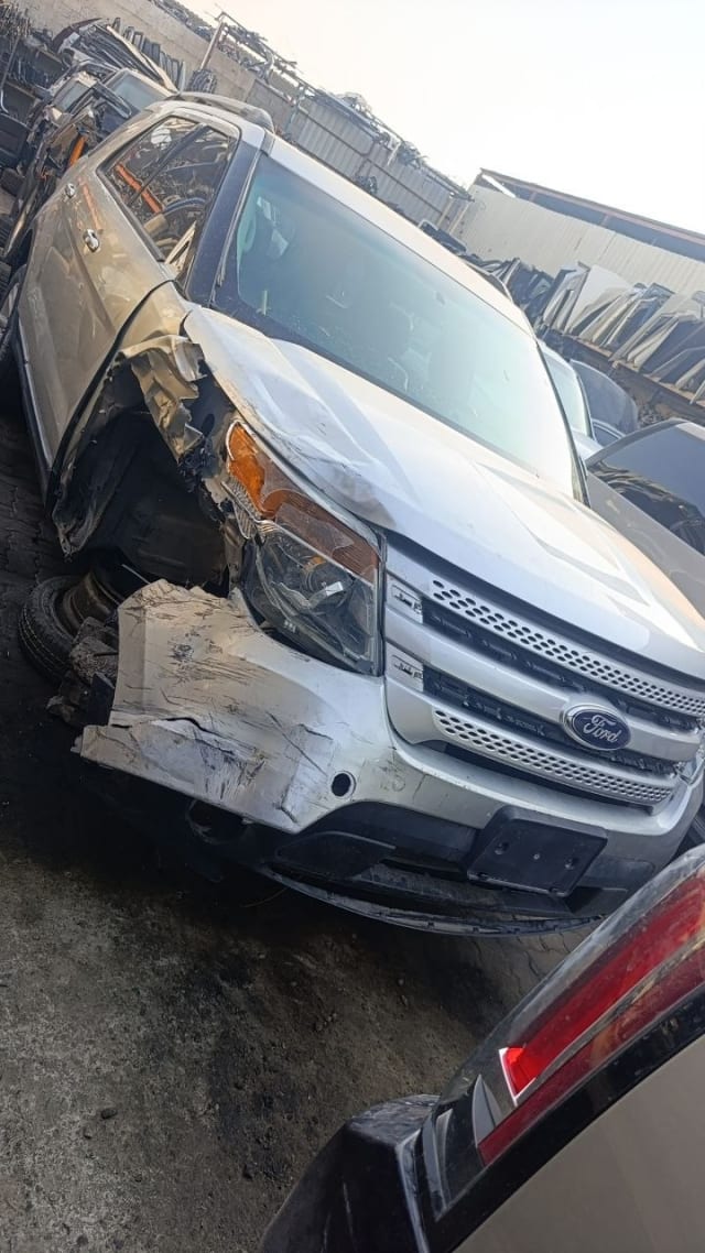 Silver Ford Explorer SUV front — grille, headlight, bumper and hood with front damage, Sharjah market