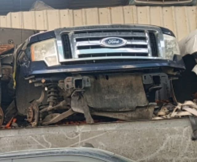 Dark blue Ford F-150 front halfcut — grille, Ford emblem, headlights and bumper, Sharjah market
