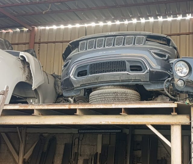 Dark grey Jeep Grand Cherokee front cut — grille, front bumper and headlight, Sharjah market