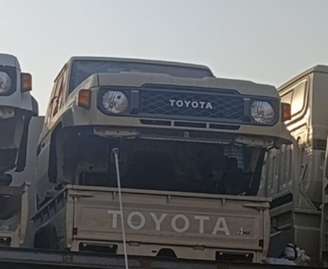 Beige Toyota Land Cruiser 70 Series halfcut front — grille, round headlights and cabin, Sharjah market