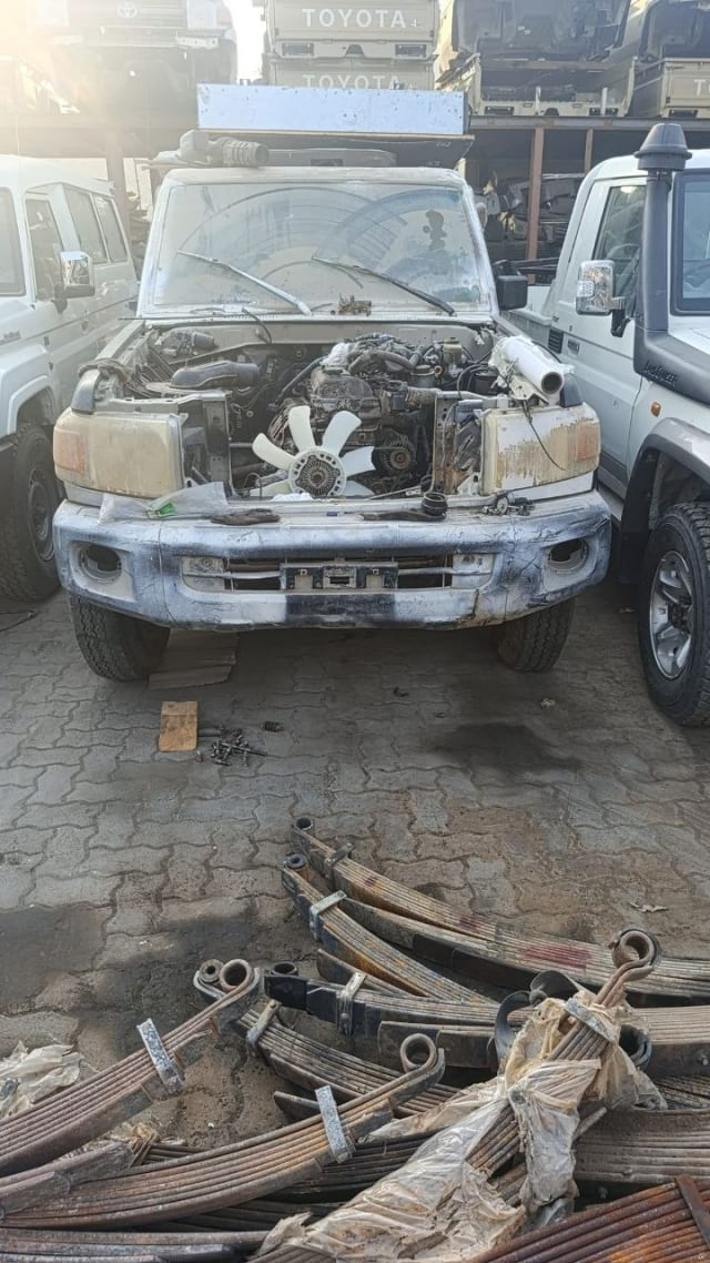 White Toyota Land Cruiser 70 Series halfcut — front bumper, engine bay and fan, Sharjah market