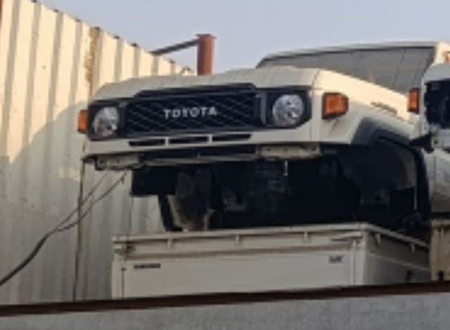 White Toyota Land Cruiser 70 Series front halfcut — grille, headlights and fenders, Sharjah market