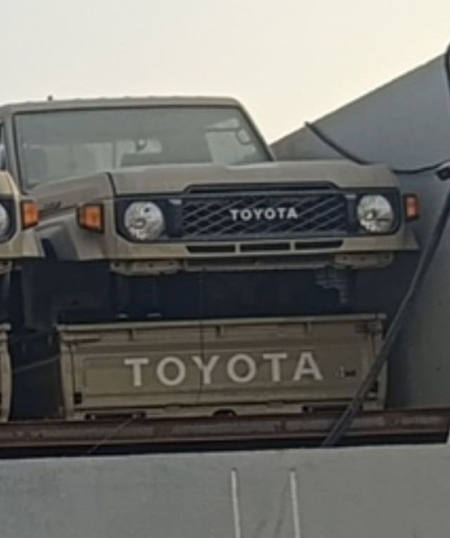 Tan Toyota Land Cruiser 70 Series front — grille, round headlights, bumper and tailgate, Sharjah market