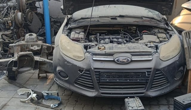 Grey Ford Focus front halfcut — bumper, grille, headlights and open engine bay, Sharjah market