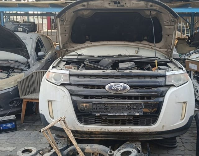 White Ford Edge SUV front cut — bumper, grille, headlights and open engine bay, Sharjah market