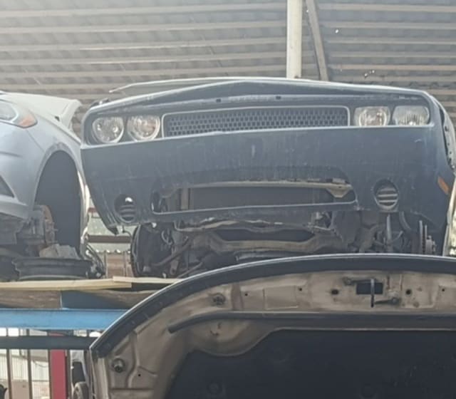 Dark blue Dodge Challenger coupe front cut — bumper, grille and dual headlights, Sharjah market
