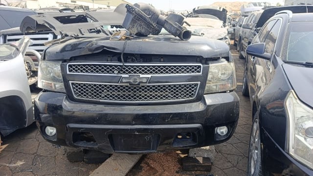 Black Chevrolet Tahoe SUV front halfcut — chrome grille, headlights and front bumper, Sharjah market