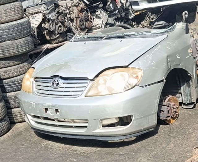 Light silver Toyota Corolla sedan front halfcut — bumper, grille, headlights and hood, Sharjah market