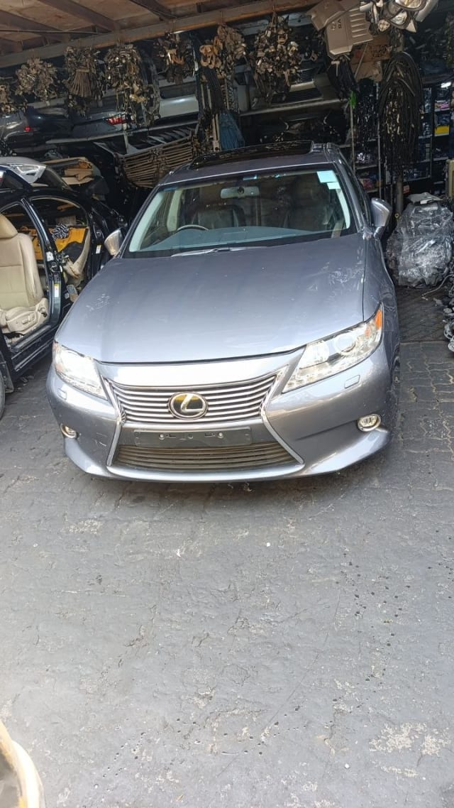 Silver Lexus ES sedan front halfcut — grille, headlights, bumper and hood, Sharjah market