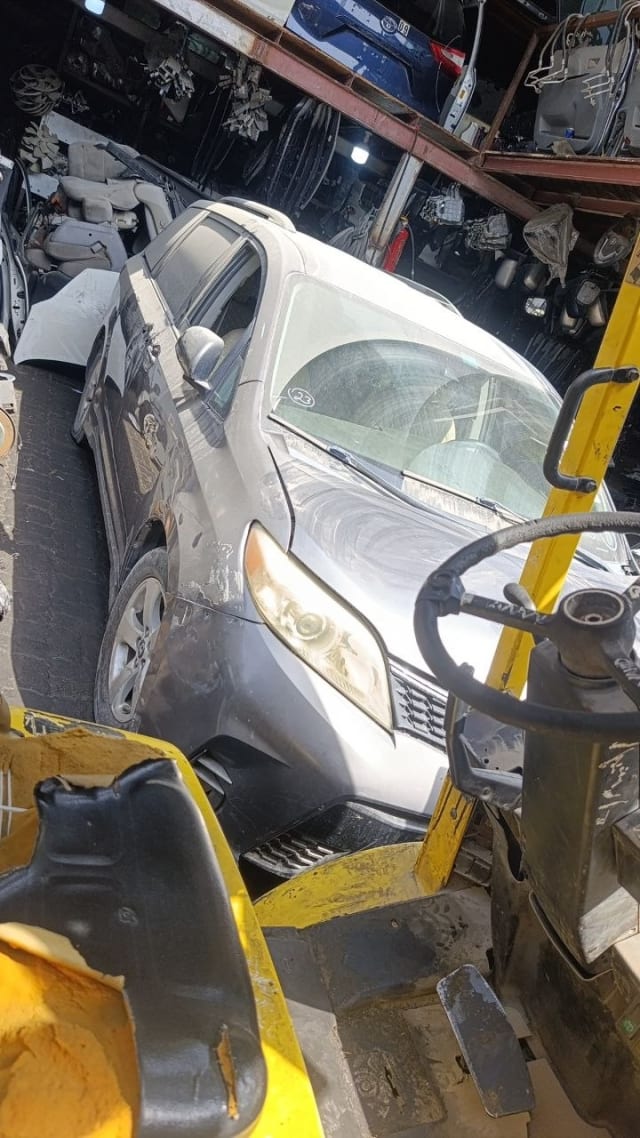 Silver Toyota Sienna minivan car for parts — front bumper, grille, headlight and hood, Sharjah market