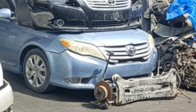 Light blue Toyota Avalon sedan front halfcut — grille, headlight, fender and subframe, Sharjah market