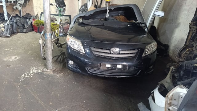 Dark grey Toyota Corolla sedan front halfcut — bumper, grille, headlights and hood, Sharjah market