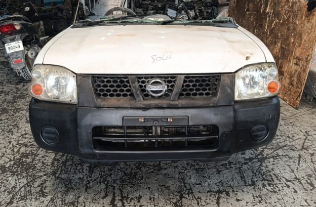 White Nissan Navara pickup front cut — hood, headlights, grille and bumper, Sharjah market