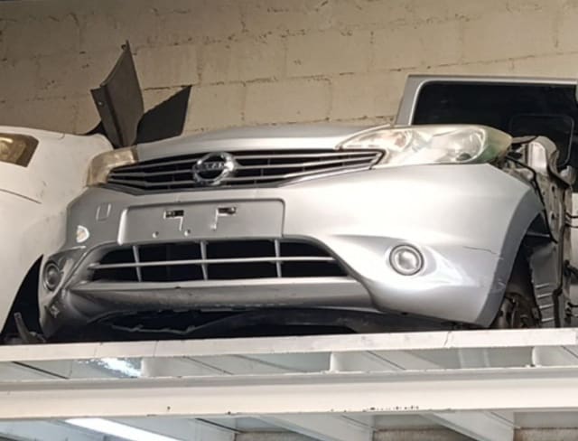 Silver Nissan Tiida hatchback front cut — bumper, grille, headlights and fog lamps, Sharjah market