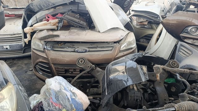 Brown Ford Kuga/Escape SUV front halfcut — bumper, grille with Ford badge, headlights and hood, Sharjah market