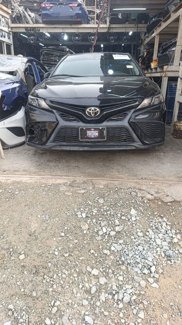 Black Toyota Camry sedan front cut — bumper, grille and headlights, Sharjah market