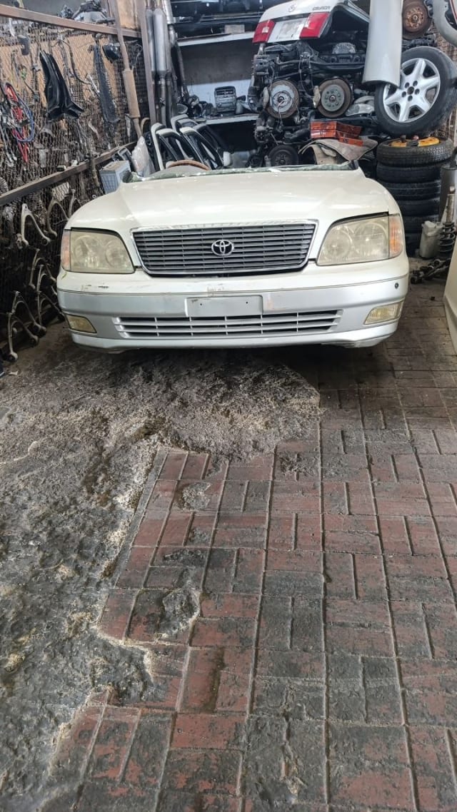 Pearl white Toyota Celsior sedan front halfcut — bumper, grille and headlights, Sharjah market