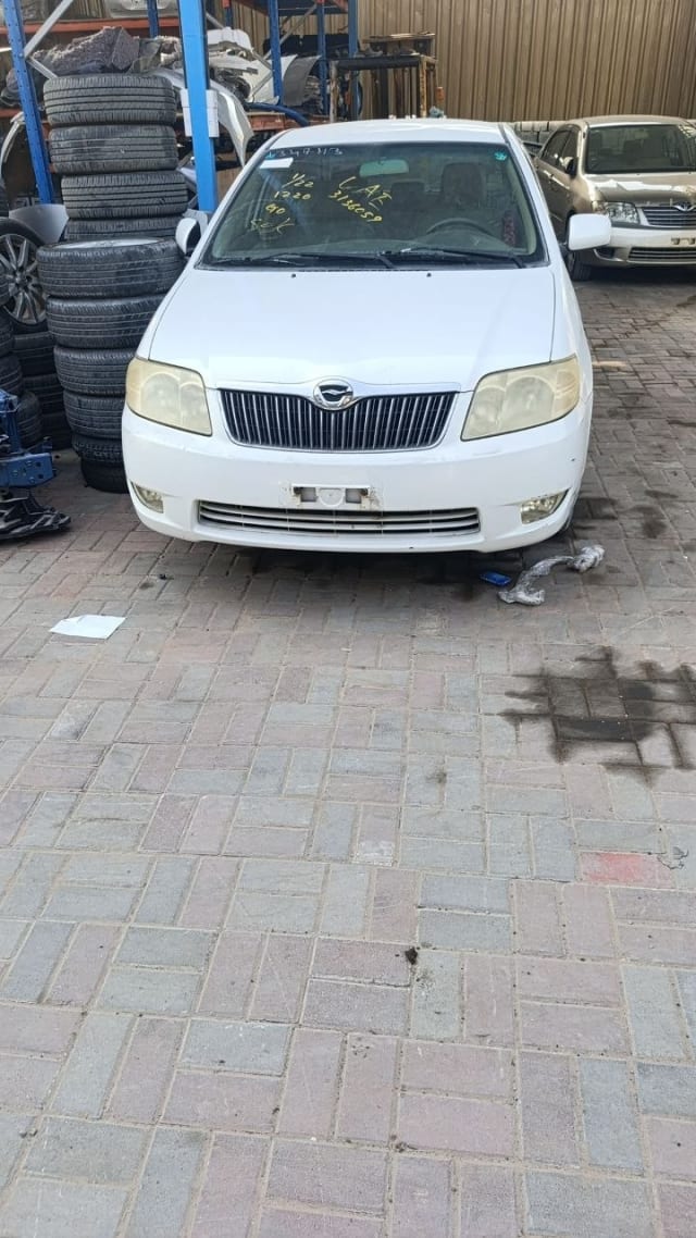 White Toyota Corolla sedan front — bumper, grille, headlights and hood, Sharjah market