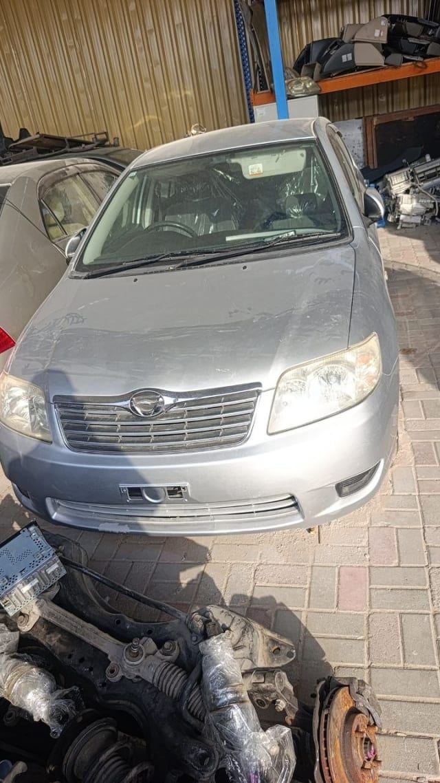 Silver Toyota Corolla sedan front cut — bumper, grille, headlights and hood, Sharjah market
