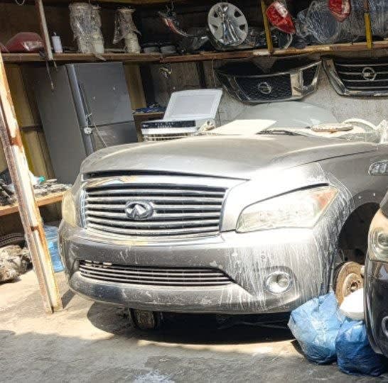 Silver-grey Infiniti QX56/QX80 SUV front halfcut — grille, bumper, headlights and hood, Sharjah market