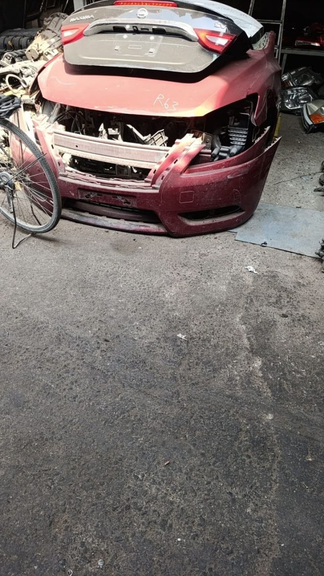Dark red Nissan Maxima front cut — front bumper and radiator support, Sharjah market