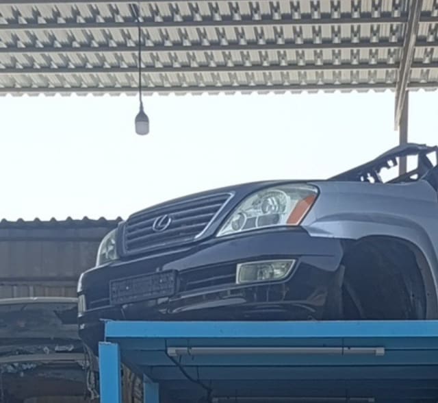 Dark Lexus GX470 SUV front halfcut — grille, headlights, fog light and front bumper, Sharjah market