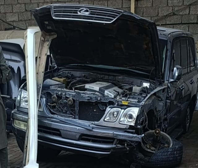 Black Lexus LX470 SUV halfcut with open hood — engine bay, grille, headlights and front bumper, Sharjah market