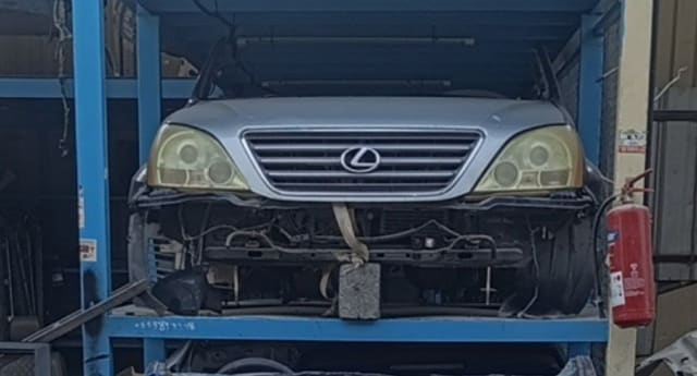 Silver Lexus GX470 SUV front halfcut — grille, headlights and radiator support on rack, Sharjah market
