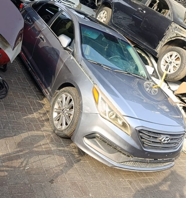 Grey Hyundai Sonata sedan car for parts — front bumper, grille, headlight, hood and wheel, Sharjah market