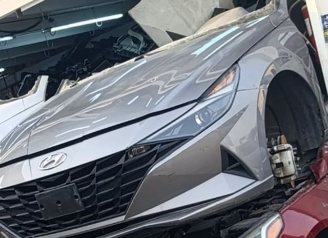 Silver Hyundai Elantra sedan front halfcut — hood, grille, bumper and headlight, Sharjah market