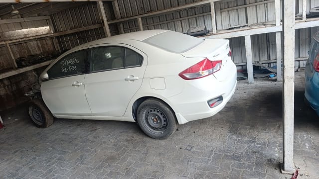 White Suzuki Ciaz sedan rear side — doors, bumper, tail light and trunk lid, Sharjah market