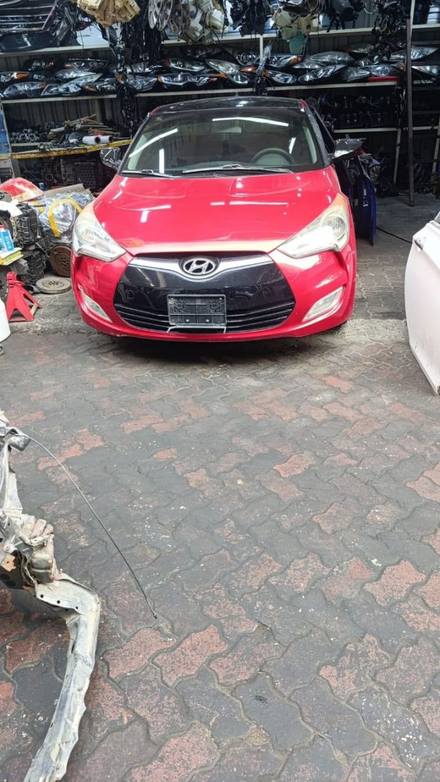 Red Hyundai Veloster front halfcut — hood, headlights, grille and bumper, Sharjah market
