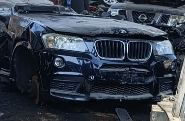 Dark blue BMW X3 SUV front halfcut — grille, headlights, hood and bumper, Sharjah market