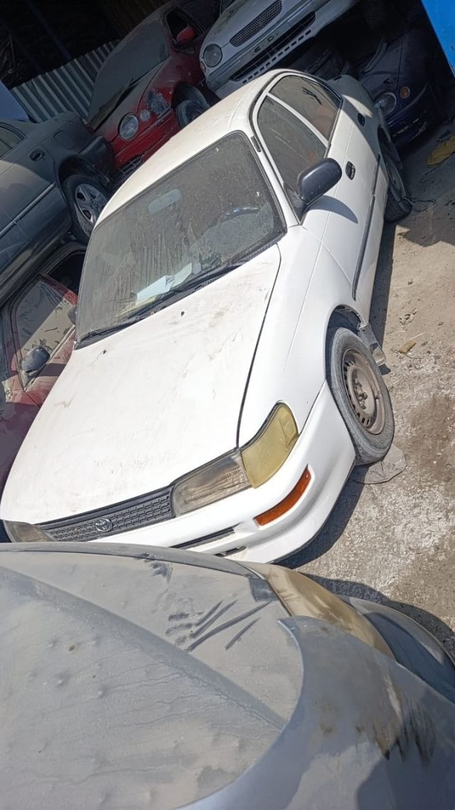 White Toyota Corolla sedan front — hood, grille, headlights and bumper, Sharjah market