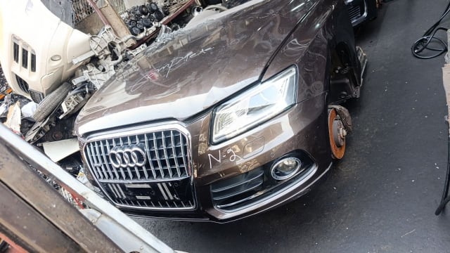 Brown Audi Q5 SUV front halfcut — grille, hood, headlight and front bumper, Sharjah market
