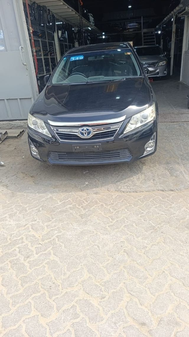 Black Toyota Camry sedan front — bumper, chrome grille, headlights and hood, Sharjah market