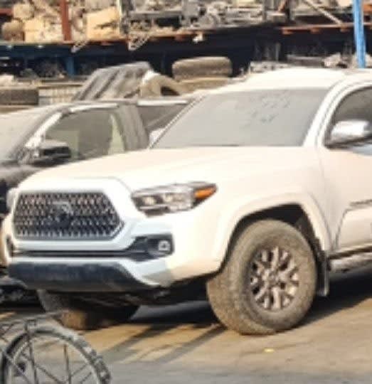 White Toyota Tacoma pickup for parts — front bumper, grille, headlights and hood, Sharjah market