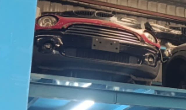 Red and black MINI Cooper hatchback front halfcut — grille, headlights and bumper, Sharjah market