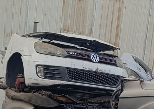 White Volkswagen Golf GTI front halfcut — bumper, red-trim GTI grille and headlight, Sharjah market