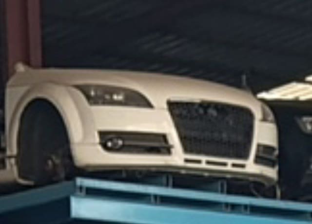 White Audi TT coupe front halfcut — bumper, single-frame grille, headlight and fender, Sharjah market