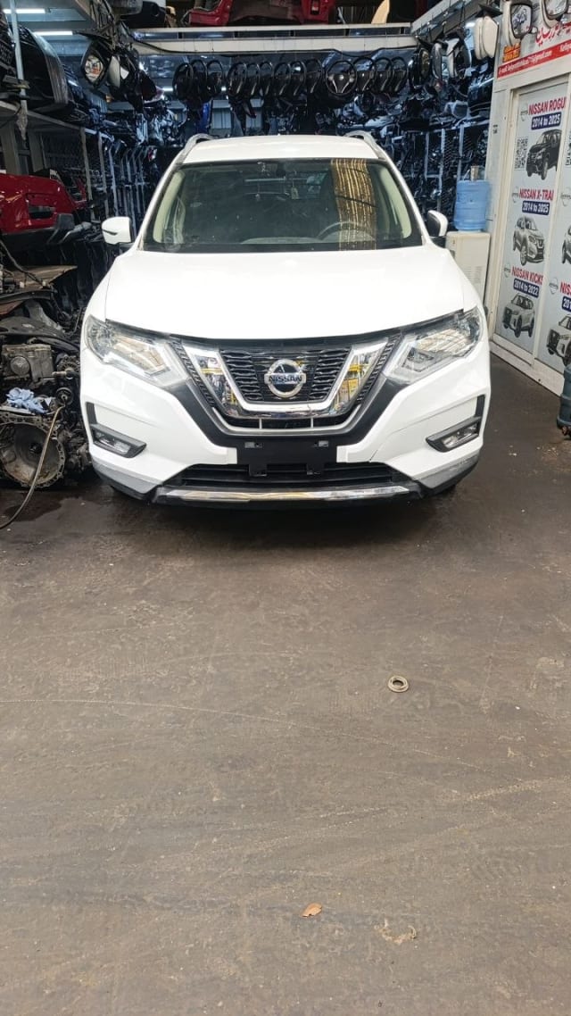 White Nissan X-Trail SUV front — bumper, chrome grille, headlights and hood, Sharjah market