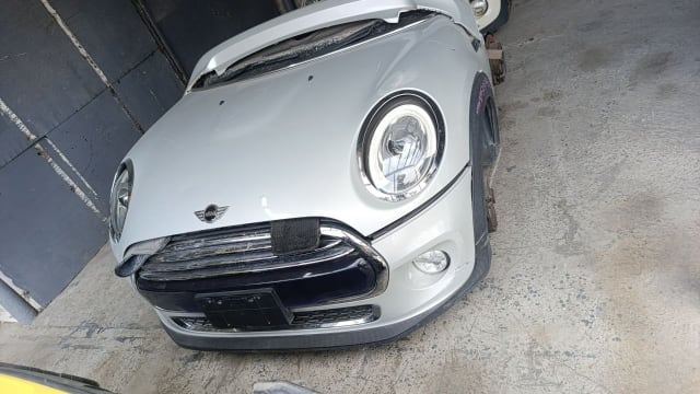Silver MINI Cooper hatchback front cut — bumper, chrome grille, round headlight and hood, Sharjah market