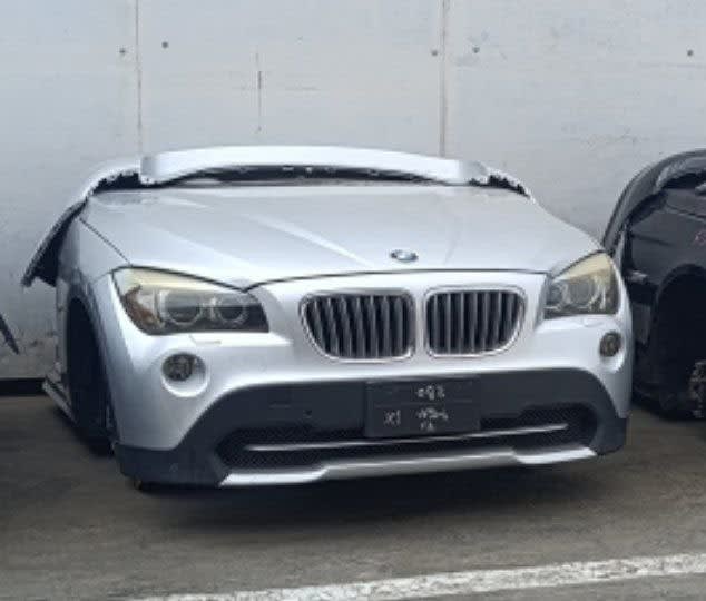 Silver BMW X1 SUV front halfcut — hood, kidney grille, bumper and headlights, Sharjah market