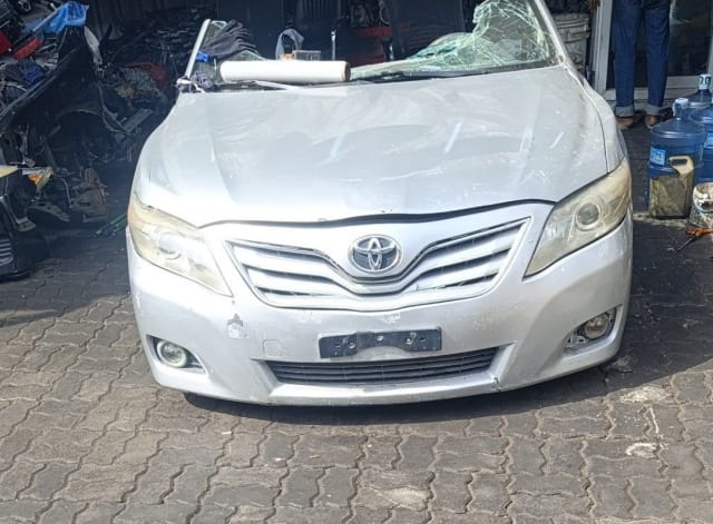 Silver Toyota Camry sedan front cut — bumper, grille, headlights and hood, Sharjah market