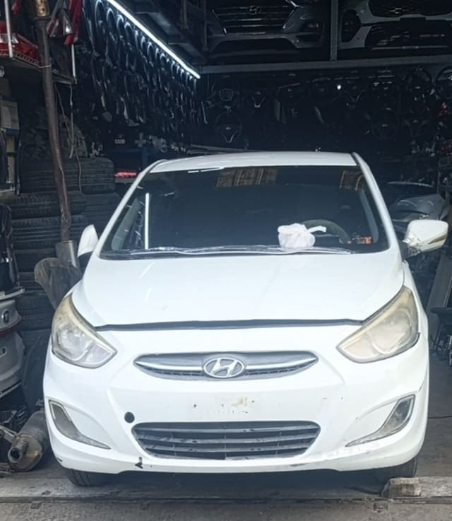 White Hyundai Accent sedan front end — bumper, grille, headlights and hood, Sharjah market