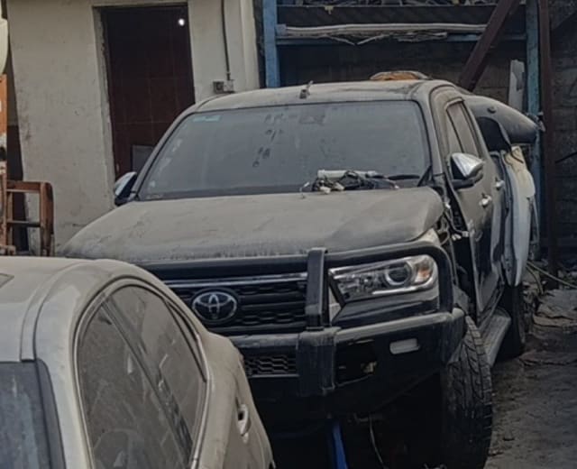 Dark grey Toyota Hilux pickup front — bull-bar bumper, grille and headlights, Sharjah market