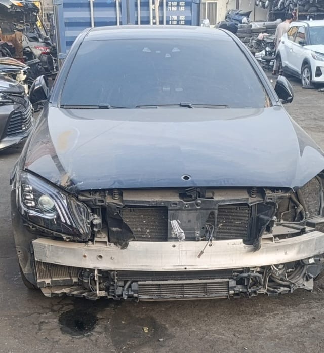 Dark grey Mercedes-Benz C-Class halfcut front — hood, headlight, radiator support and coolers exposed, Sharjah market