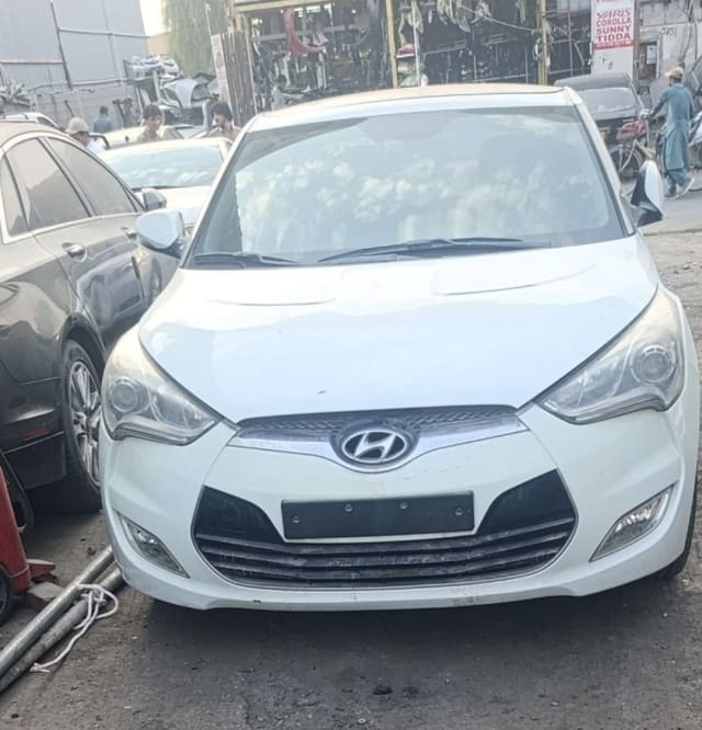 White Hyundai Veloster front — bumper, chrome grille and headlights, Sharjah market